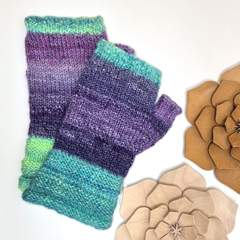 A pair of fingerless gloves with green cuffs and finger trim, and purple hands